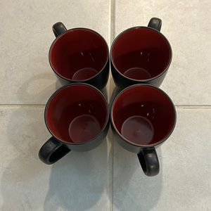 4 black and red mugs.